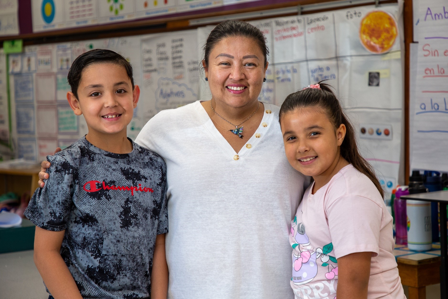 Mission View teacher Ms. Gomez-Peralta poses with two of her students