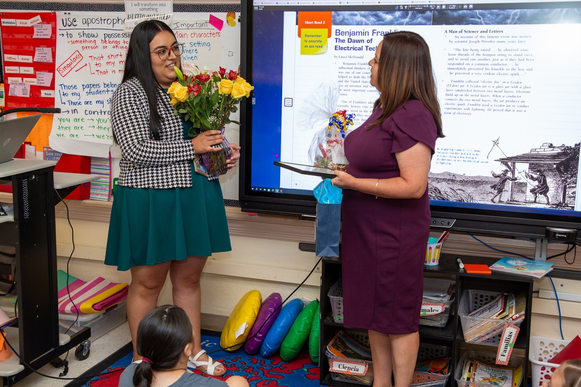 Mission View teacher Delia Sotelo holds a bouquet of flowers in recognition of being awarded by Tucson Values Teachers