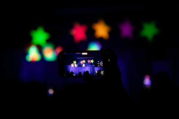 A phone captures an image of the glowing stars on stage
