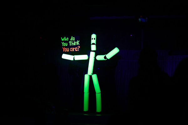 A glowing puppet dances next to the words Who do you think you are?