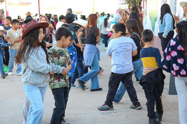 Students perform a square dance together