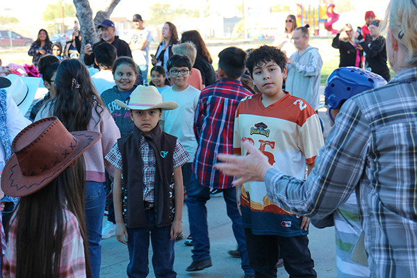 Students listen to instructions before they dance